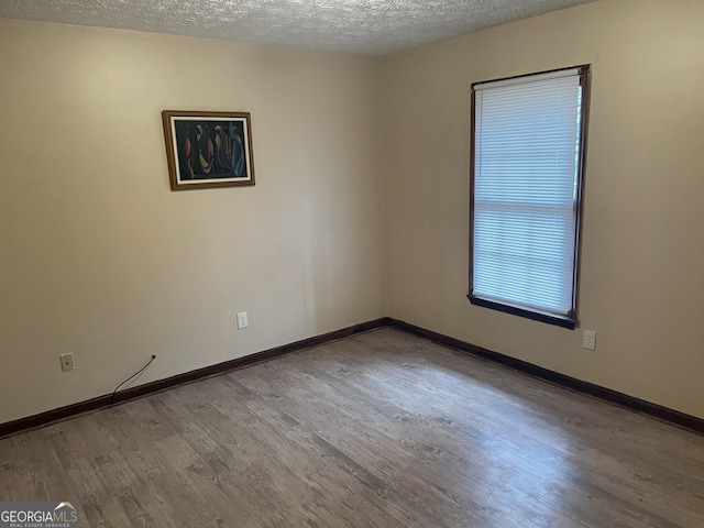405415 Chase Dr, Fayetteville, GA 30214 - empty room featuring wood finished floors and a textured ceiling