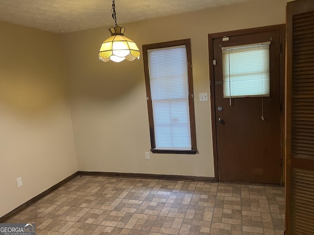 405415 Chase Dr, Fayetteville, GA 30214 - unfurnished dining area with baseboards and brick patterned flooring
