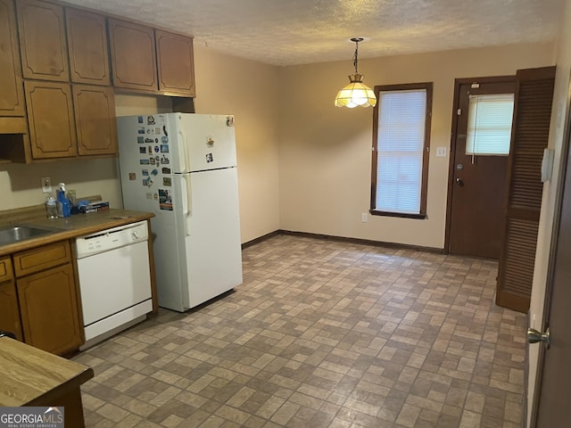 405415 Chase Dr, Fayetteville, GA 30214 - kitchen featuring white appliances, brick patterned flooring, pendant lighting, and a textured ceiling