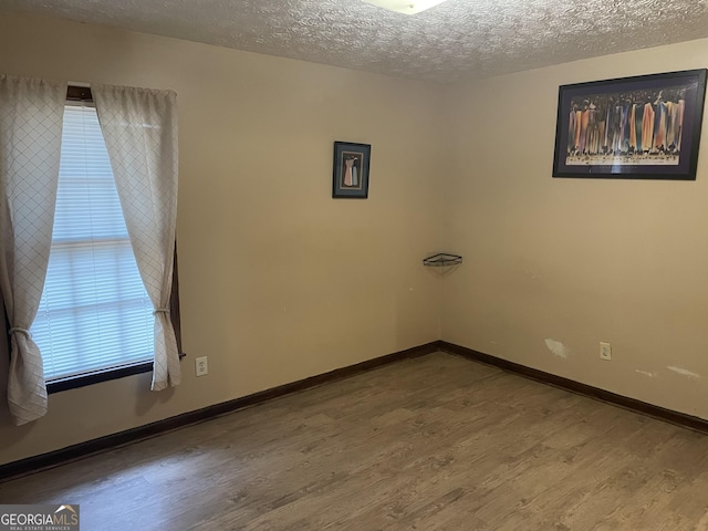 405415 Chase Dr, Fayetteville, GA 30214 - empty room with wood finished floors and a textured ceiling