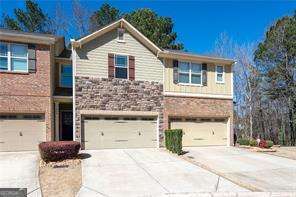 traditional-style home with a garage and driveway