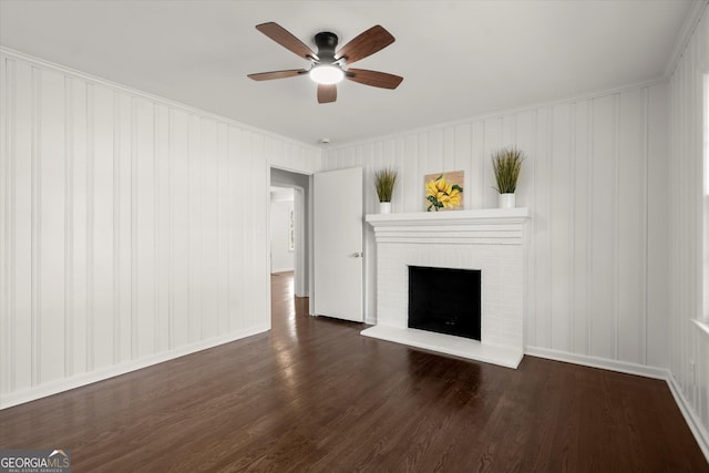 unfurnished living room with a brick fireplace, ceiling fan, baseboards, and wood finished floors