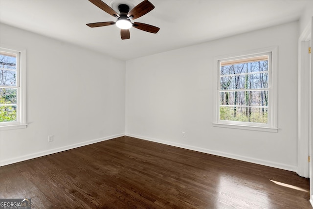 unfurnished room featuring dark wood-style floors and baseboards