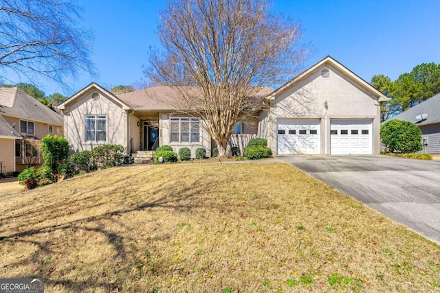 ranch-style house with a garage, stucco siding, a front lawn, and aphalt driveway