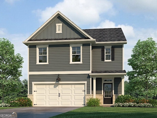 craftsman-style home featuring a shingled roof, board and batten siding, a front yard, a garage, and driveway