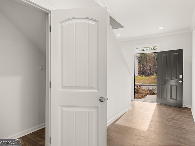 hall with ornamental molding, recessed lighting, baseboards, and wood finished floors