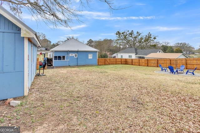 view of yard with a fire pit and a fenced backyard