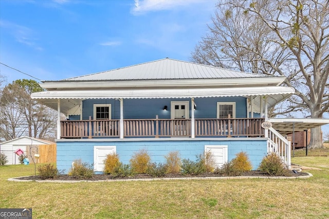 exterior space with a porch, metal roof, and a lawn