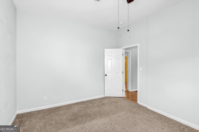 carpeted spare room with baseboards