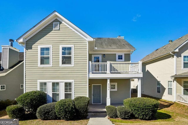 view of front of home featuring covered porch and a balcony