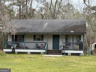 ranch-style home with covered porch and a front yard
