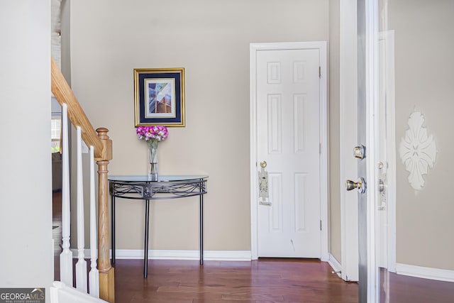 foyer featuring stairway, baseboards, and wood finished floors