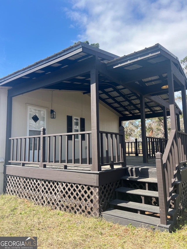 view of home's exterior featuring a porch and a carport