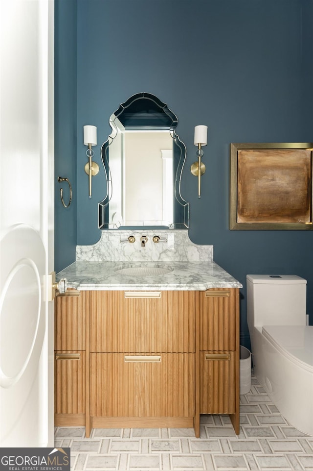 bathroom featuring toilet and vanity