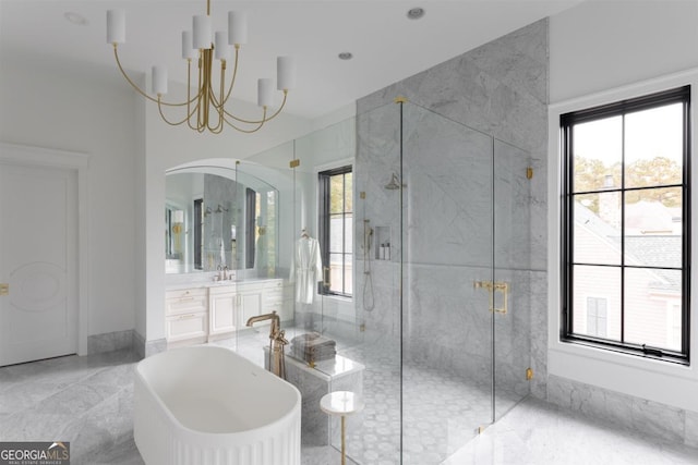 full bath featuring a chandelier, a freestanding tub, vanity, marble finish floor, and a marble finish shower