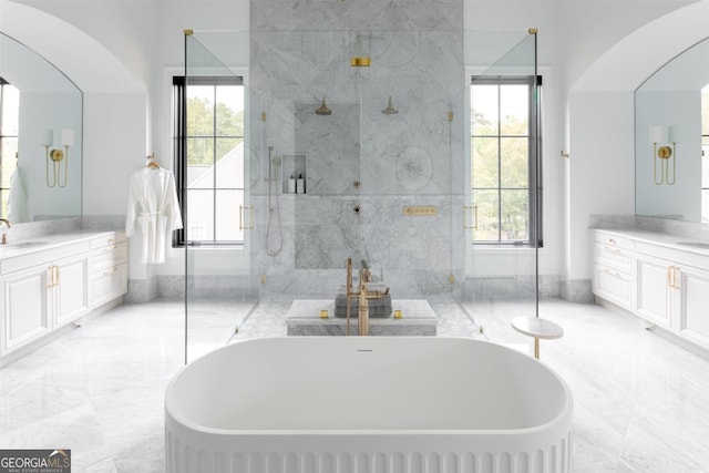 full bathroom featuring a shower stall, marble finish floor, plenty of natural light, and vanity