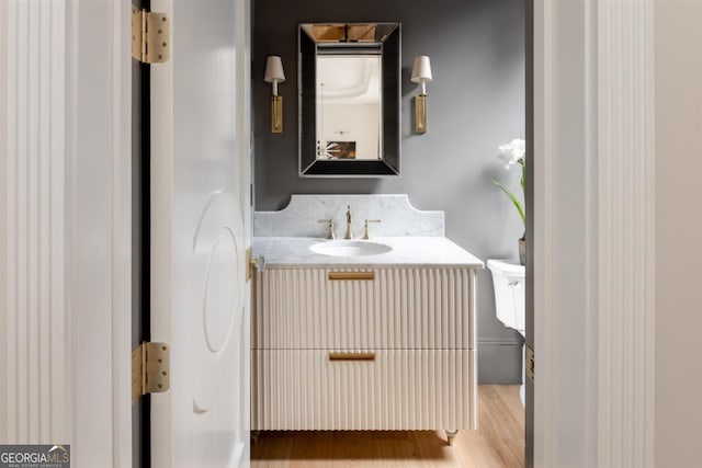 bathroom with vanity and wood finished floors