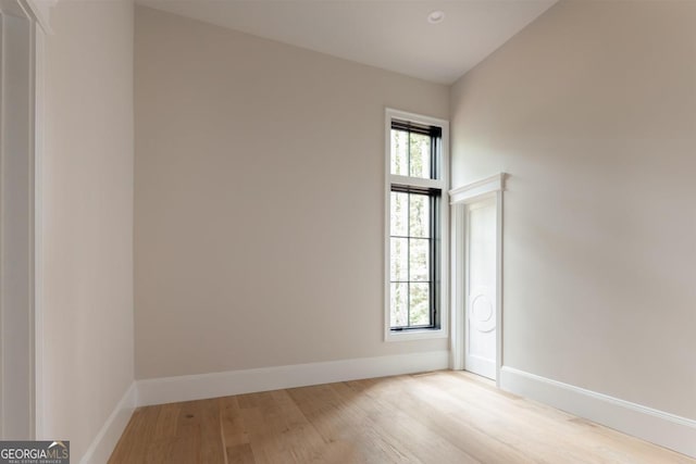 empty room featuring baseboards and wood finished floors