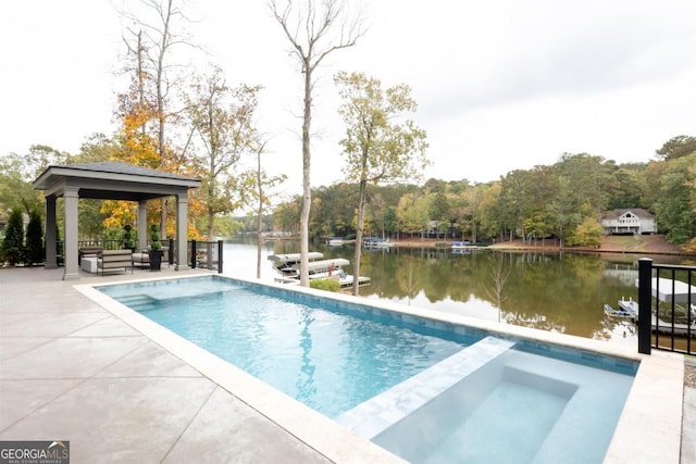 view of pool with a pool with connected hot tub, a water view, a patio, and a gazebo