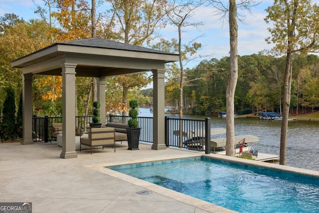 view of swimming pool featuring a water view, a patio, and a gazebo