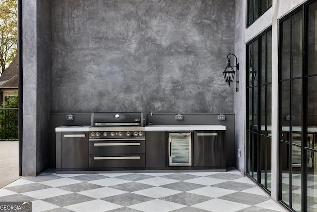 view of patio with beverage cooler and an outdoor kitchen