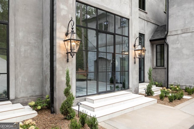 property entrance with stucco siding