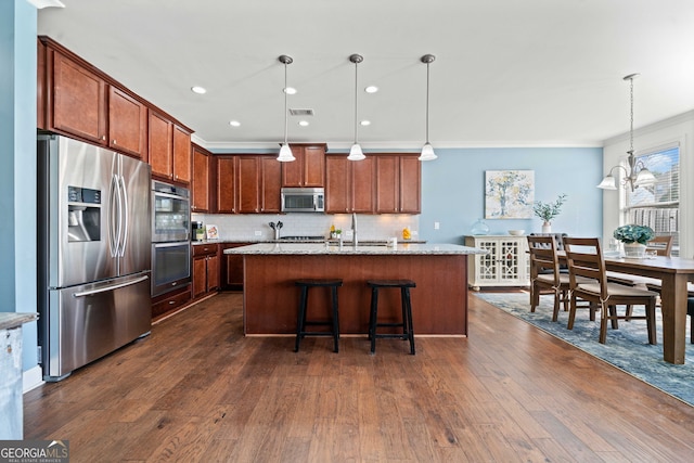 kitchen featuring dark wood-type flooring, crown molding, decorative backsplash, appliances with stainless steel finishes, and hanging light fixtures