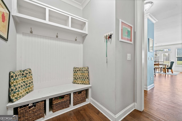 mudroom featuring dark wood finished floors, baseboards, and ornamental molding