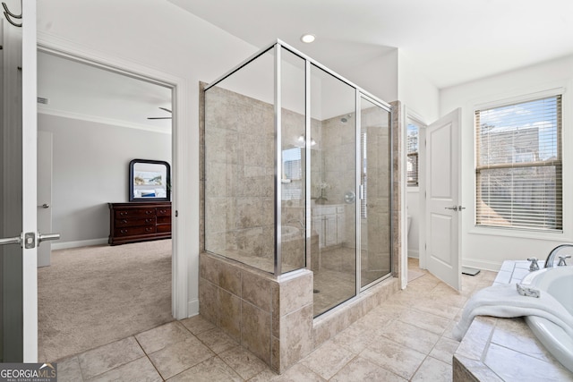 bathroom with a shower stall, crown molding, baseboards, a garden tub, and tile patterned floors