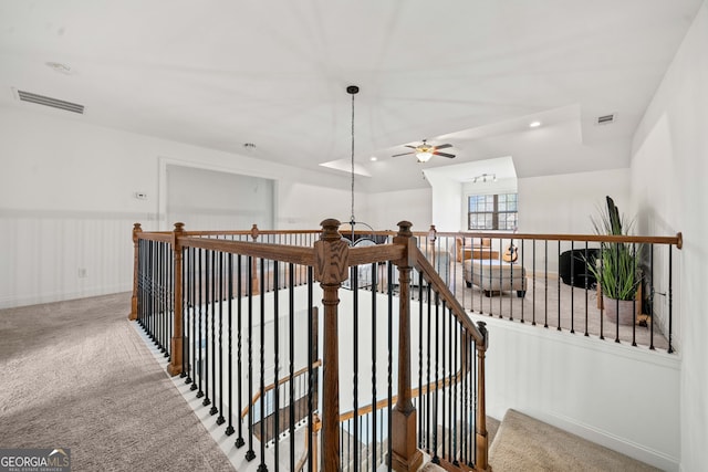 hallway featuring carpet flooring, recessed lighting, visible vents, and an upstairs landing