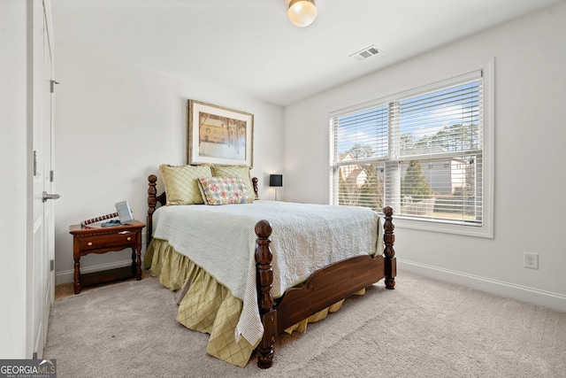 carpeted bedroom featuring visible vents and baseboards