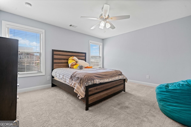 carpeted bedroom featuring visible vents, ceiling fan, and baseboards