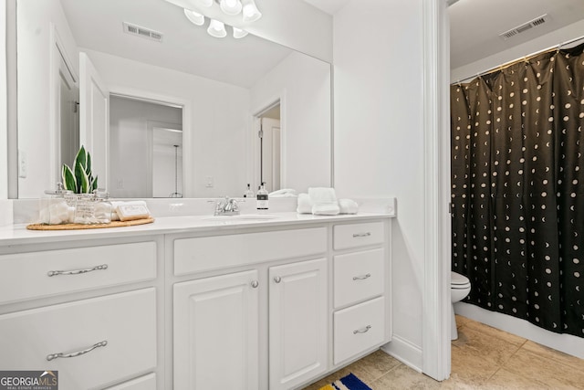 bathroom featuring tile patterned floors, visible vents, toilet, and vanity