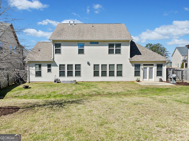 back of property featuring a patio area, a lawn, a fenced backyard, and a shingled roof