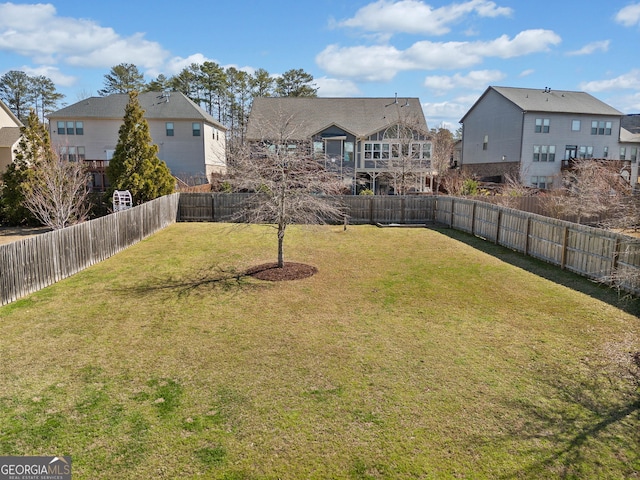 view of yard with a fenced backyard and a residential view