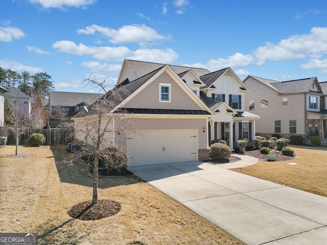 view of front of home featuring fence, a residential view, concrete driveway, metal roof, and a standing seam roof