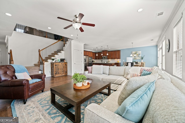 living room featuring visible vents, recessed lighting, stairs, and wood finished floors