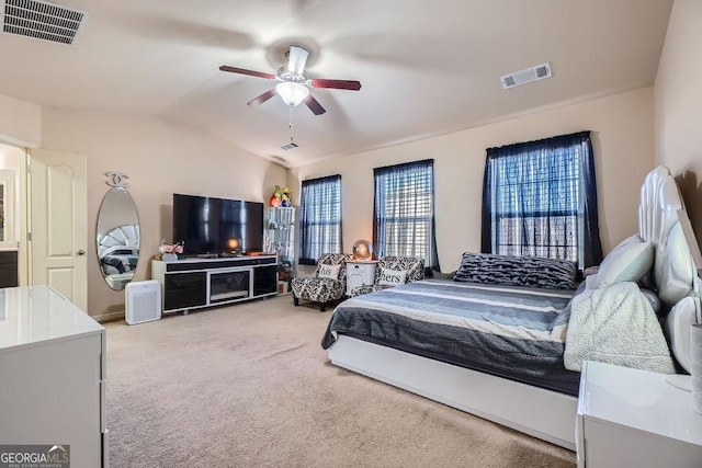 bedroom with carpet floors, visible vents, a ceiling fan, and lofted ceiling