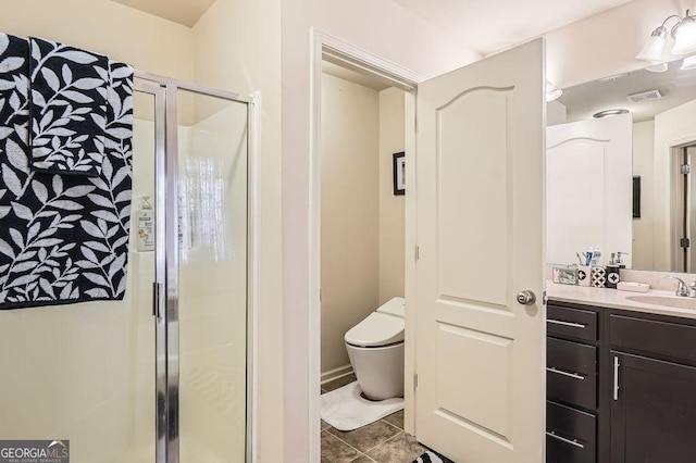 bathroom featuring visible vents, toilet, tile patterned floors, vanity, and a shower stall