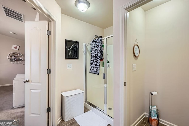 full bath with a stall shower, visible vents, and baseboards