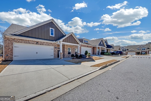 view of front of house featuring brick siding, concrete driveway, board and batten siding, a garage, and a residential view