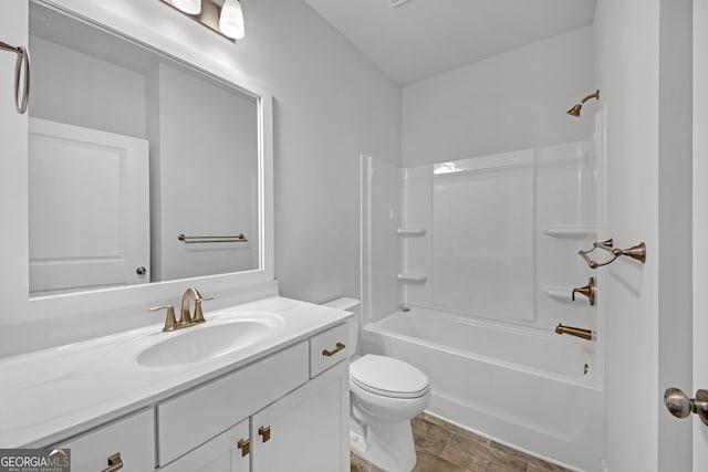 bathroom featuring washtub / shower combination, vanity, and toilet