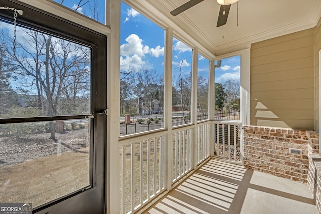 unfurnished sunroom with a ceiling fan