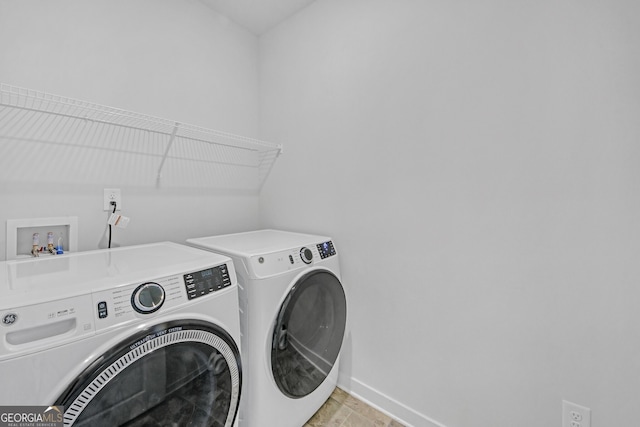 laundry area featuring baseboards, laundry area, and washer and dryer