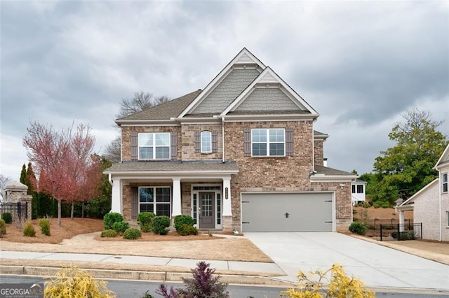 craftsman house featuring a garage, brick siding, fence, and driveway