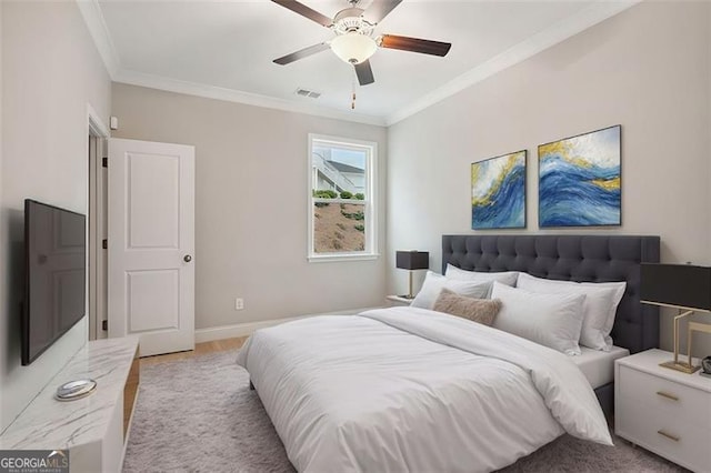 bedroom with a ceiling fan, baseboards, visible vents, and crown molding