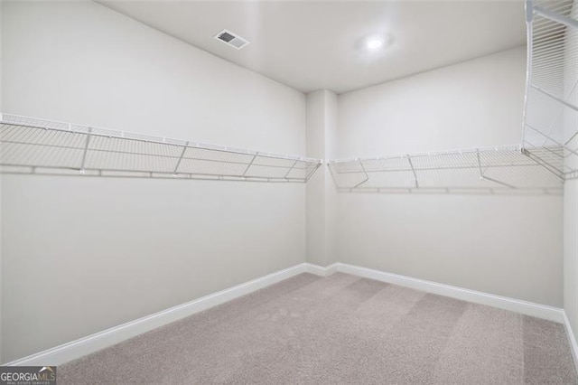 spacious closet with carpet flooring and visible vents