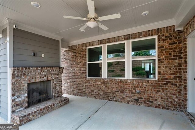 view of patio / terrace with an outdoor brick fireplace and ceiling fan