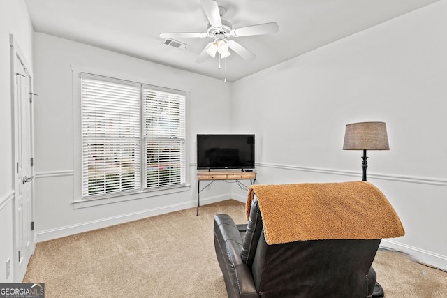 sitting room featuring visible vents, baseboards, ceiling fan, and carpet flooring