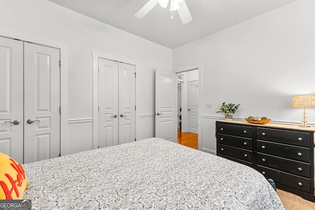 bedroom featuring two closets and ceiling fan